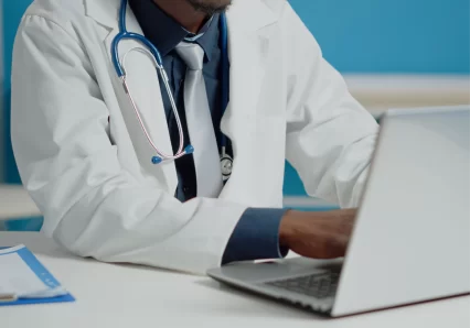 close_up_doctor_typing_laptop_keyboard_medical_cabinet_1